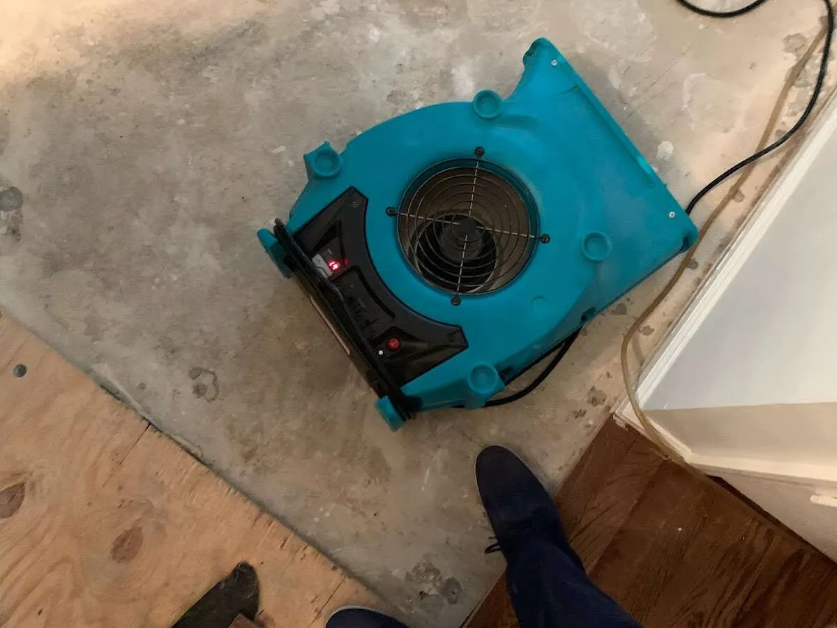Air mover drying subfloor during Commercial Water Damage Restoration in West Mifflin